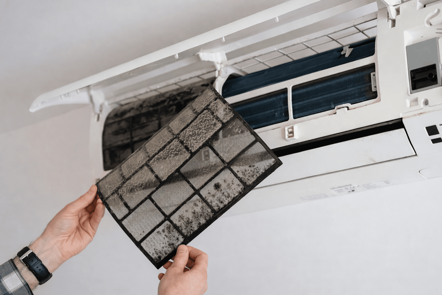 Técnico realizando Conserto de Ar Condicionado Comercial em São Paulo, ajustando componentes internos do sistema de climatização durante o reparo técnico.